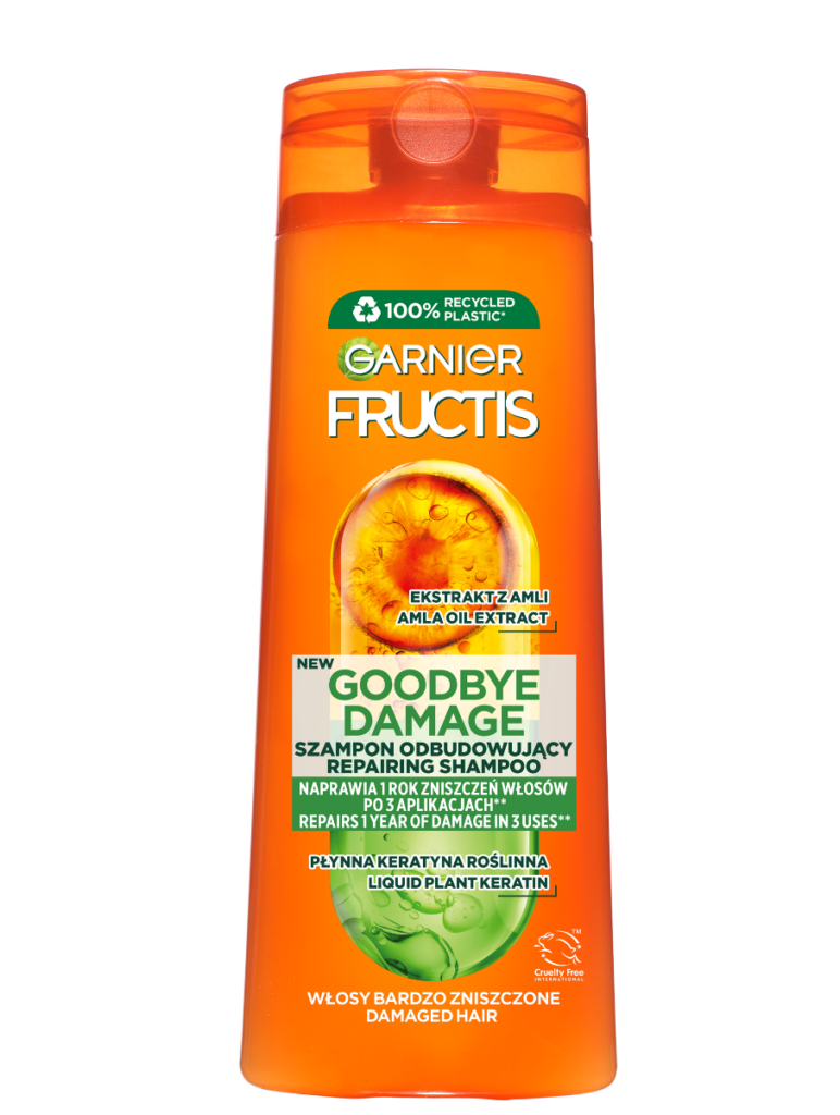 Pomarańczowa butelka szamponu Garnier Fructis stoi na białym tle, etykieta głosi "Goodbye Damage".