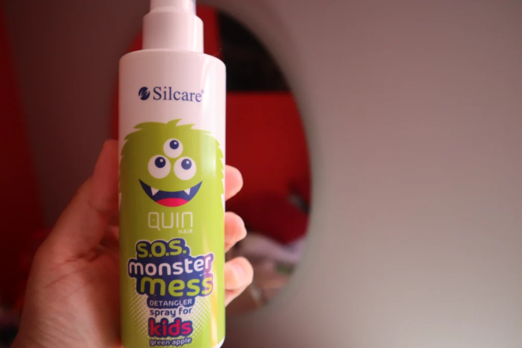 Spray do rozczesywania włosów Silcare Quin Hair S.O.S Monster Mess w kobiecej dłoni